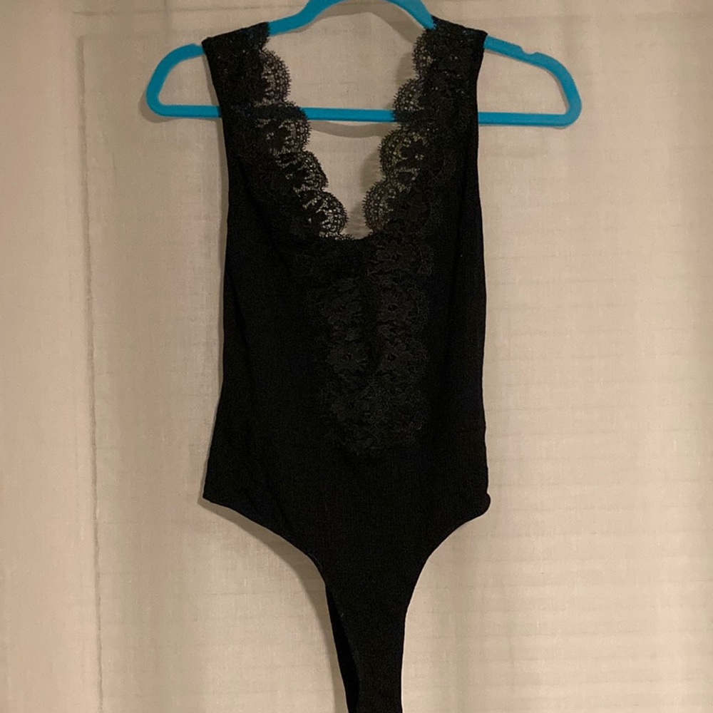 Black ribbed cotton body suit. Deep V.